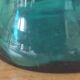 Blown glass vase with a flared neck and wavy rim.