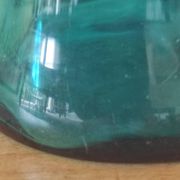 Blown glass vase with a flared neck and wavy rim.