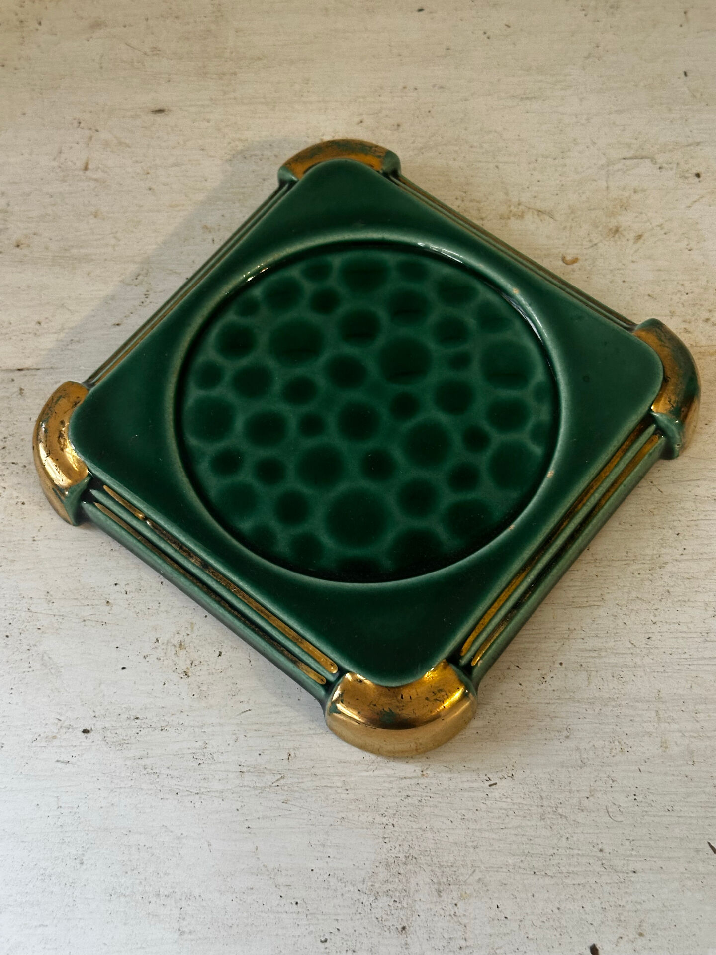 Art Deco bottle coaster in speckled green glazed ceramic and