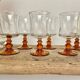 6 small amber stemmed glasses