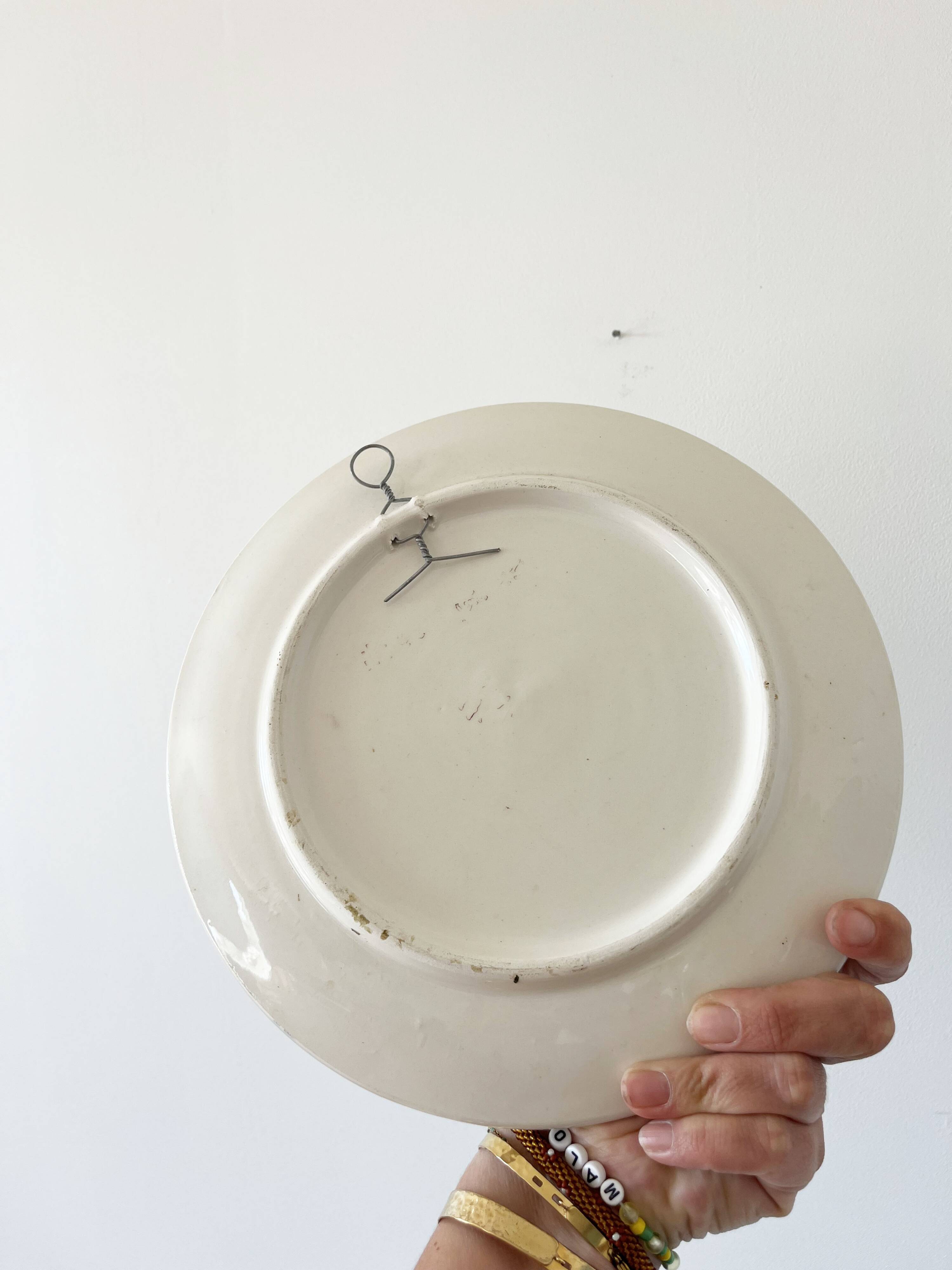 Decorative ceramic plate with sun face