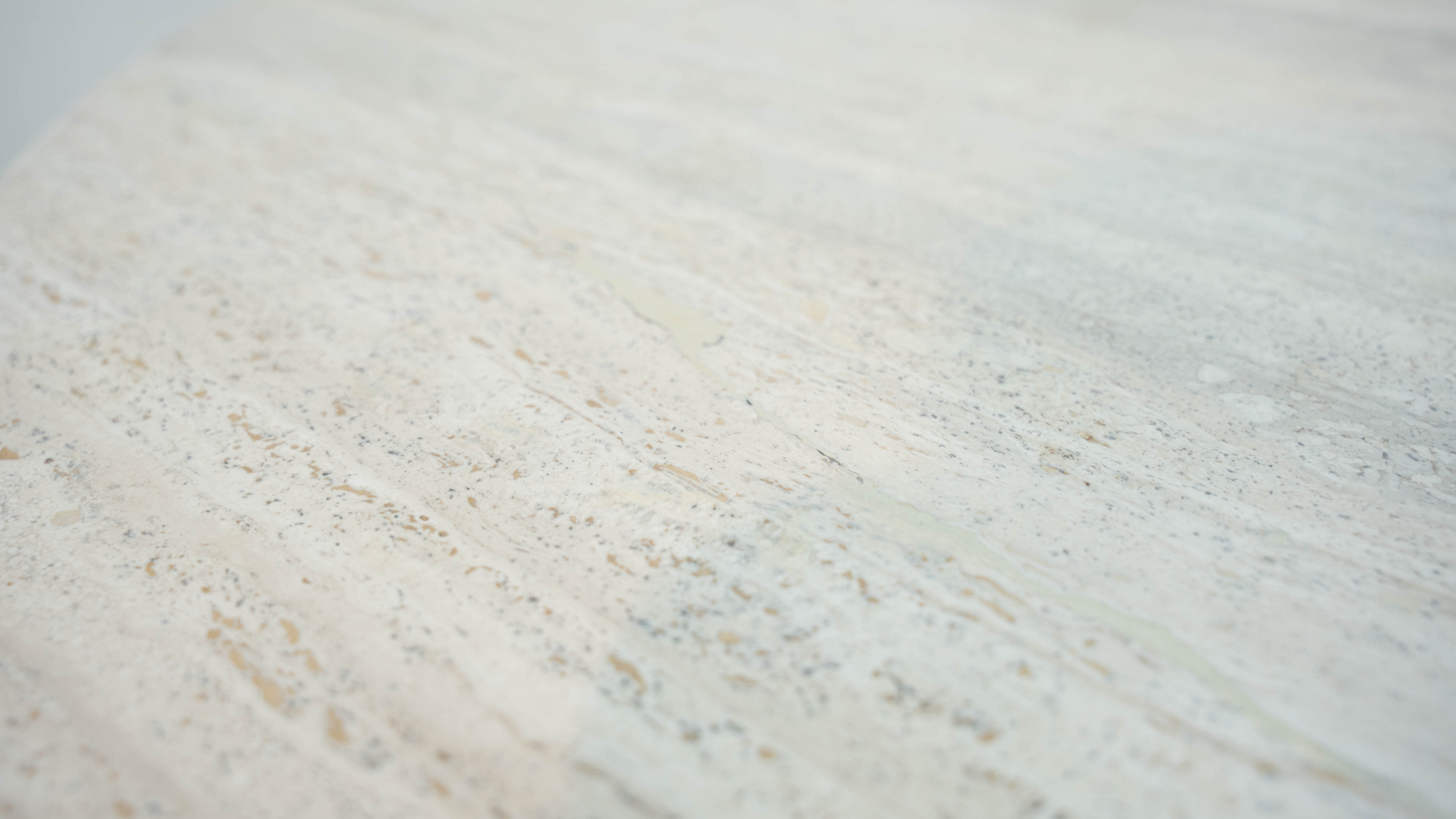 Round Belgian travertine dining table