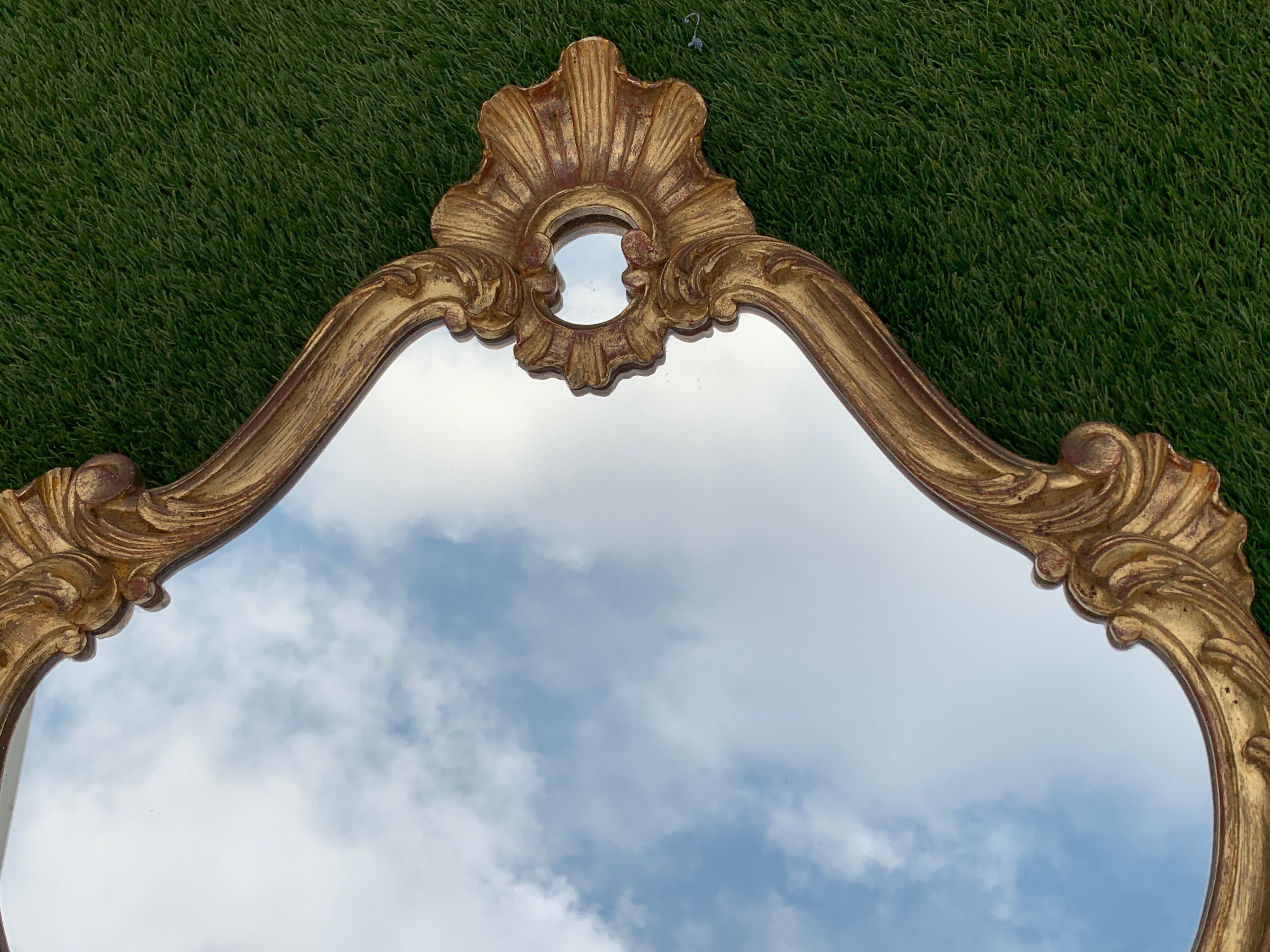 Old mirror in carved wood and gilded leaf, Louis XV rocaille style, twentieth century 59x87cm