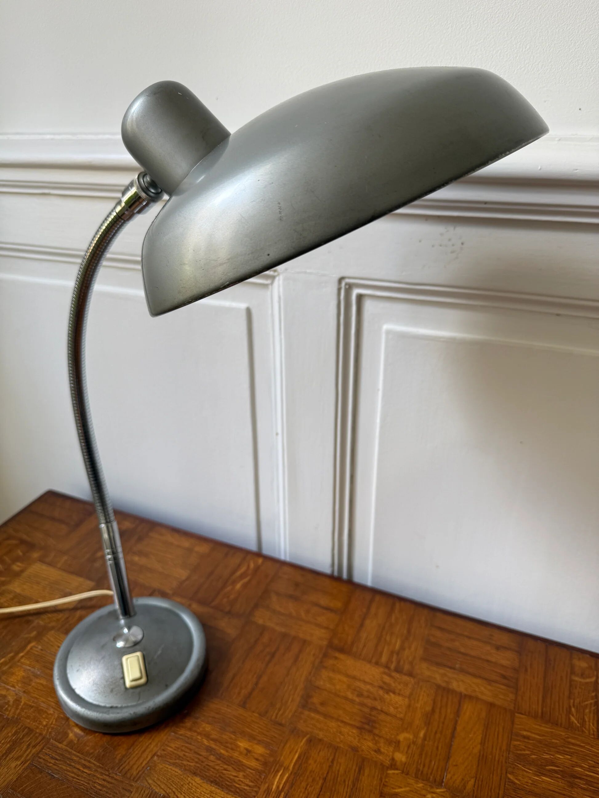 Industrial metal workshop lamp with a gooseneck.