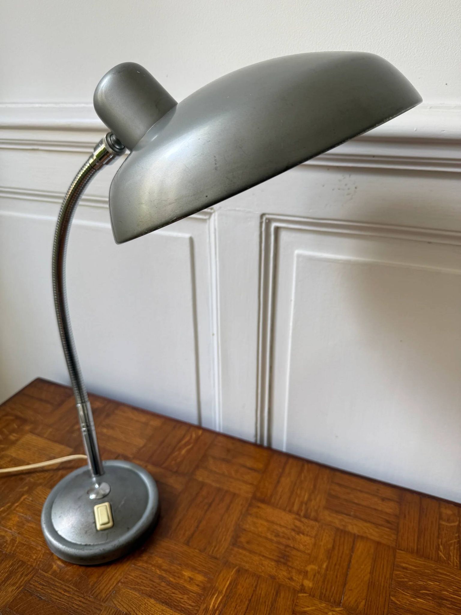 Industrial metal workshop lamp with a gooseneck.