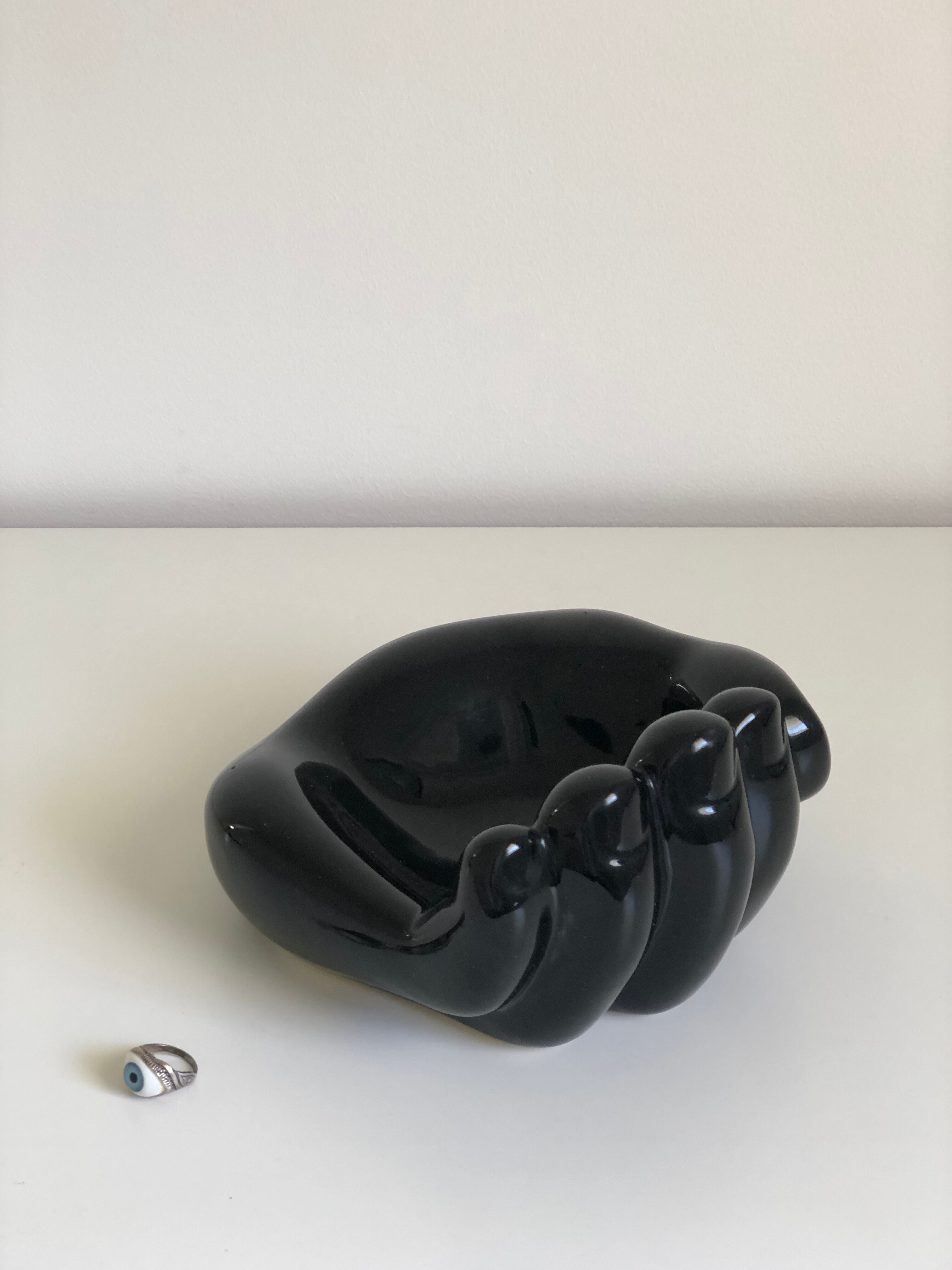 Empty black enamelled hand-shaped ceramic pocket, 1970