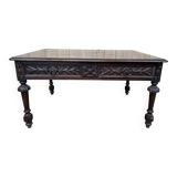 Middle table in a sculpted Louis XIII style living room.