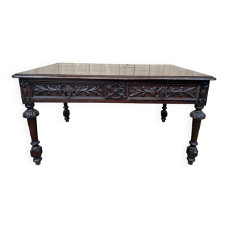 Middle table in a sculpted Louis XIII style living room.