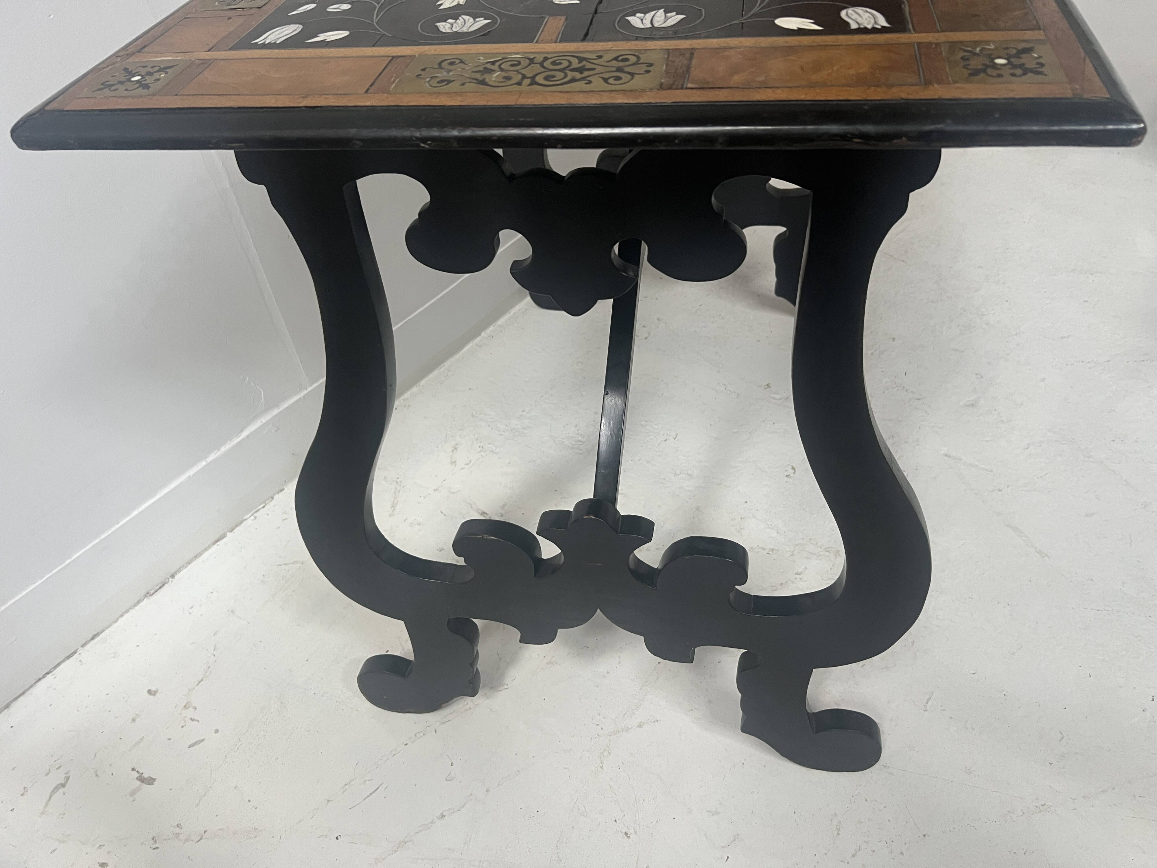 Blackened wood display table with marquetry top, Spain, 19th century.