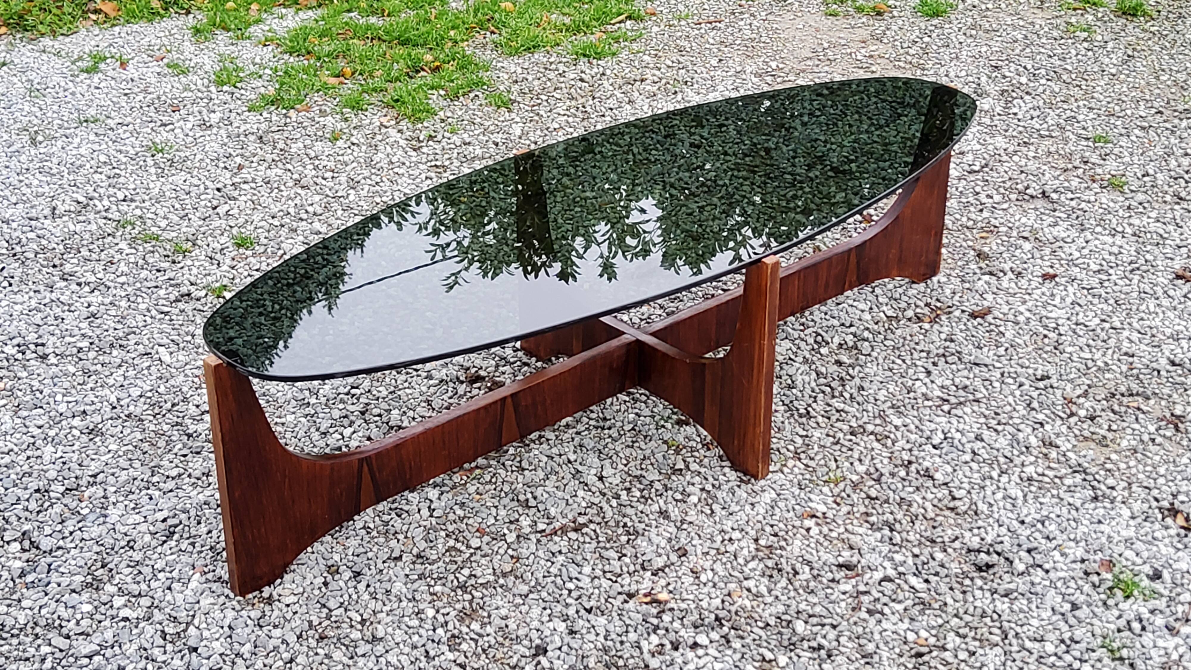 Designer coffee table by Hugues Poignant in rosewood and smoked glass from the 70s