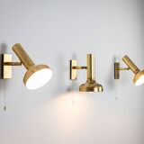 Set of three brass adjustable wall lamps