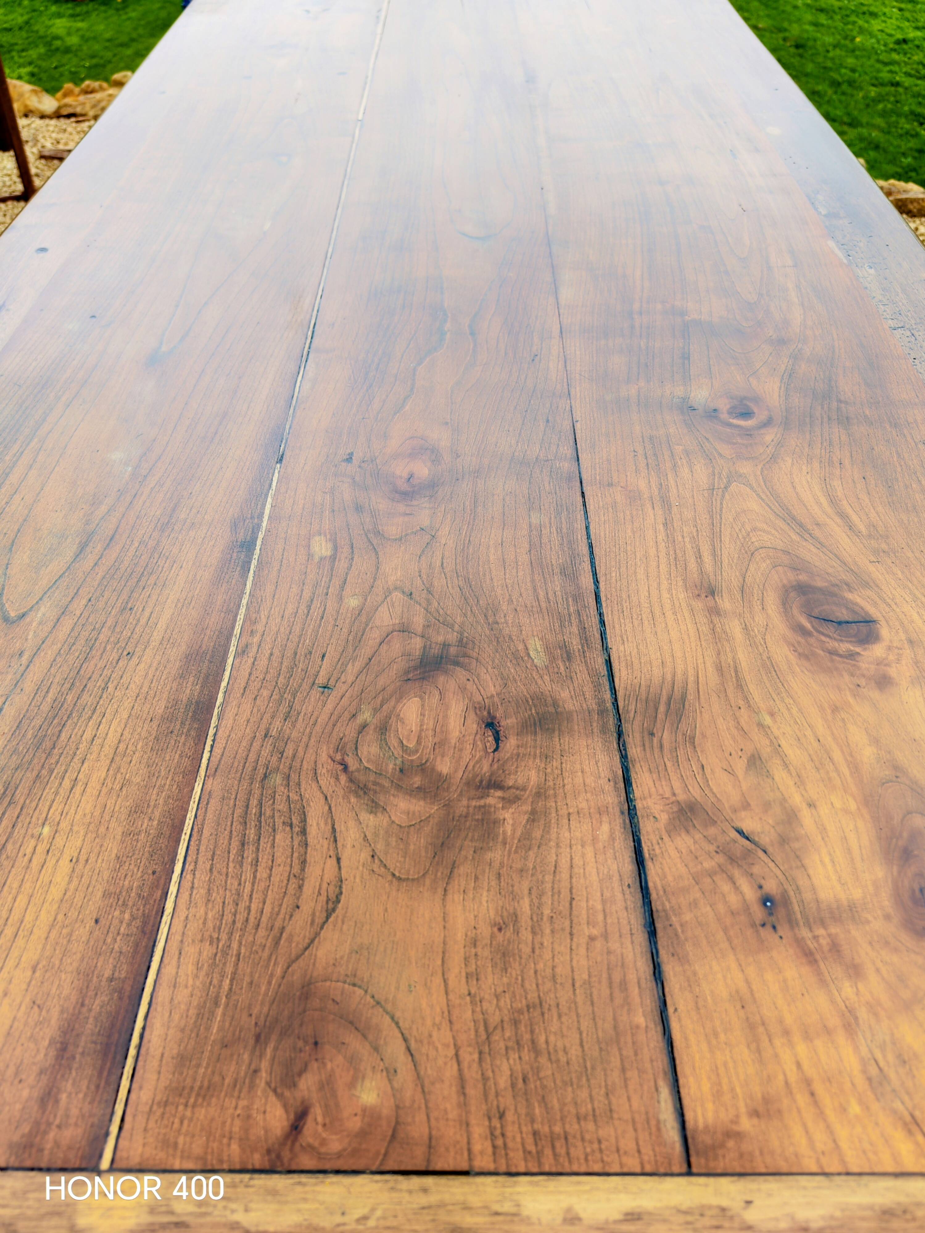 Old French farmhouse table in walnut with turned legs.