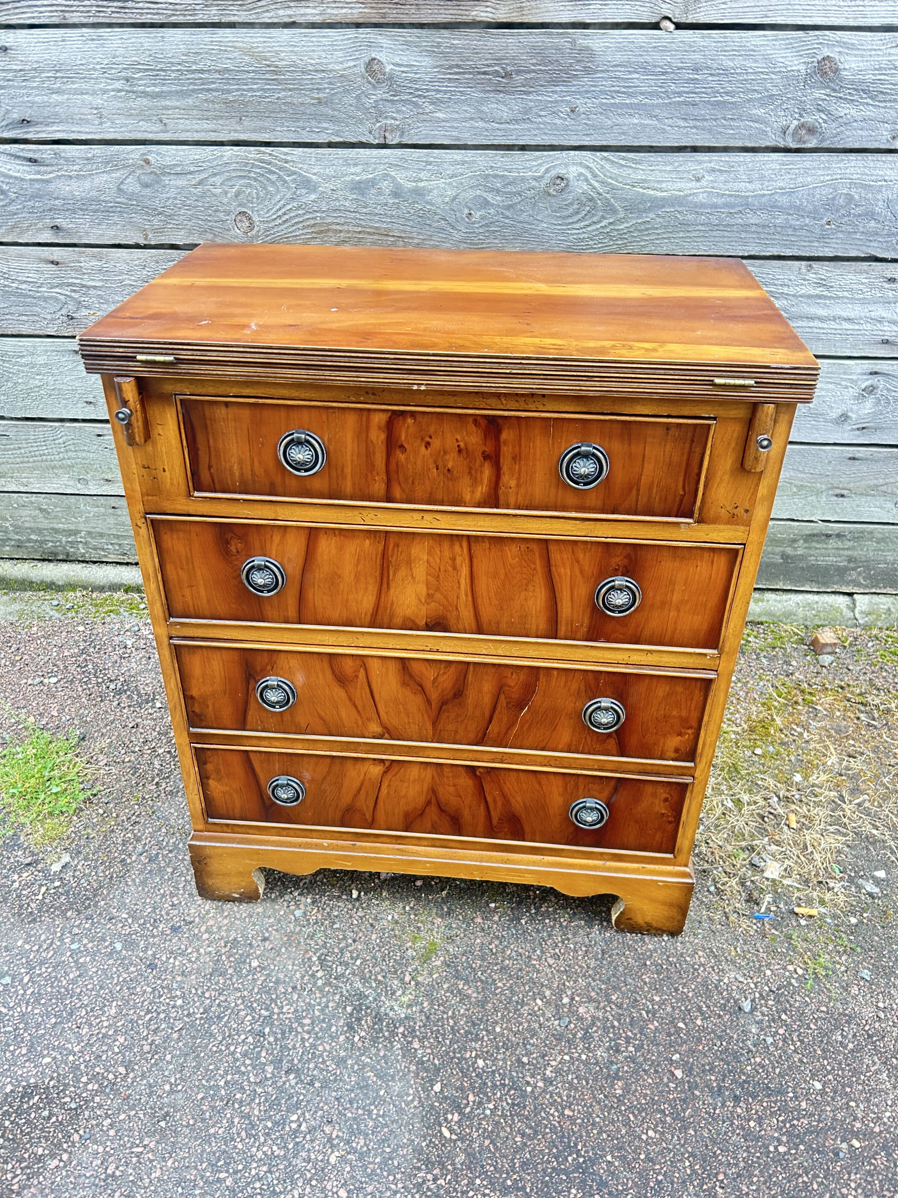 Small English chest of drawers with a folding top.