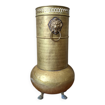Vintage brass umbrella stand with lion head handle.