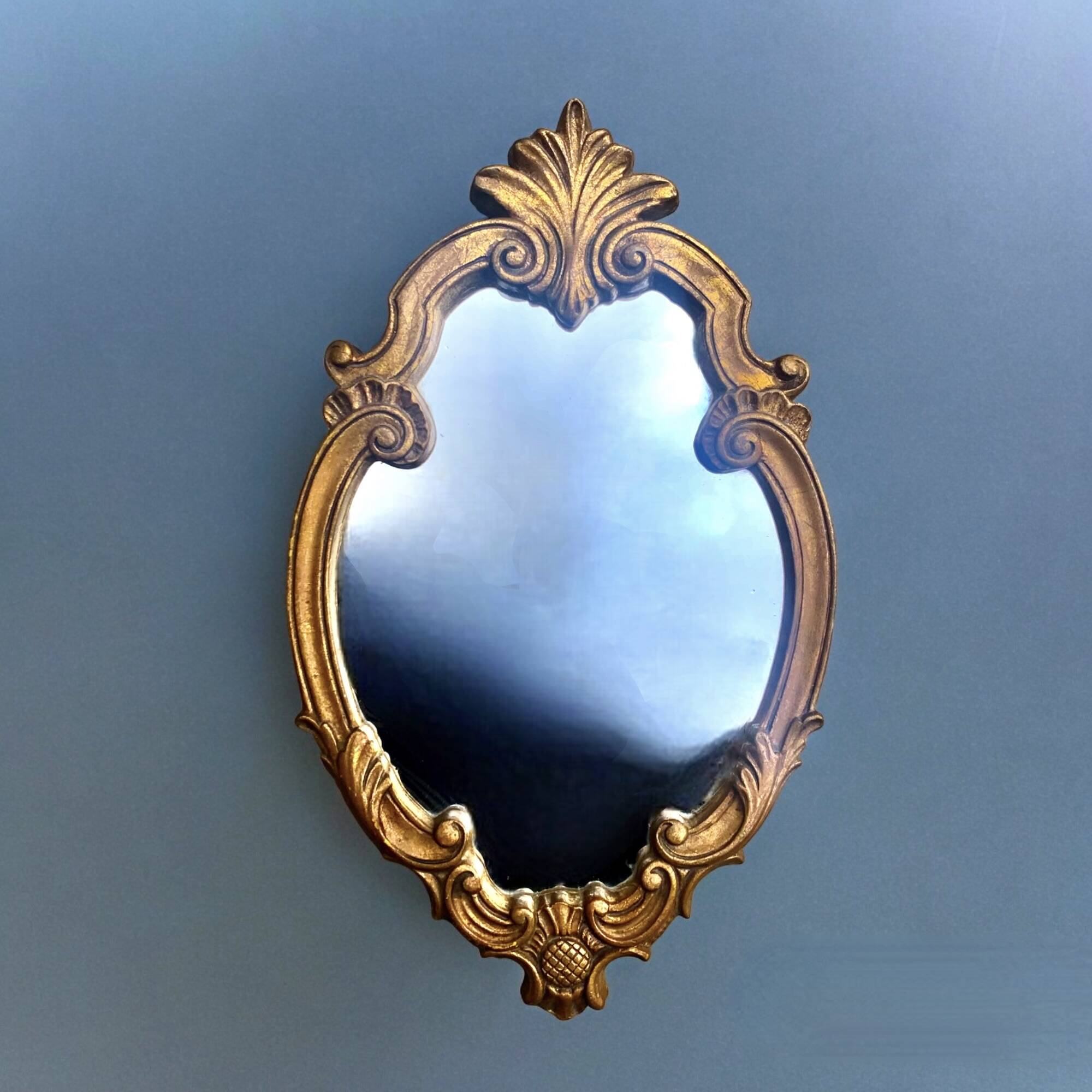 Vintage wall mirror in gold resin