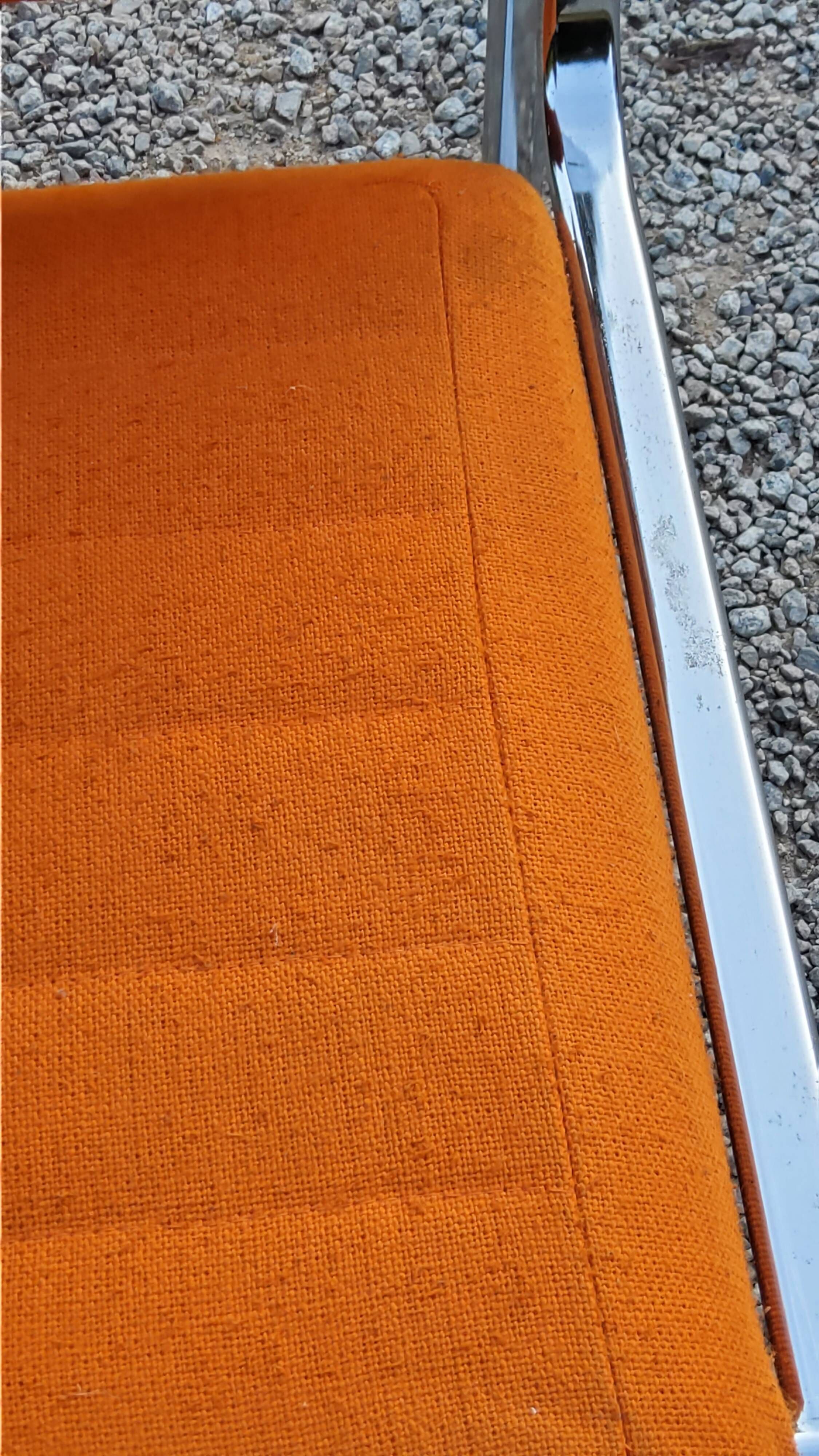 Pair of designer armchairs in orange fabrics and chrome tubes from the 70s