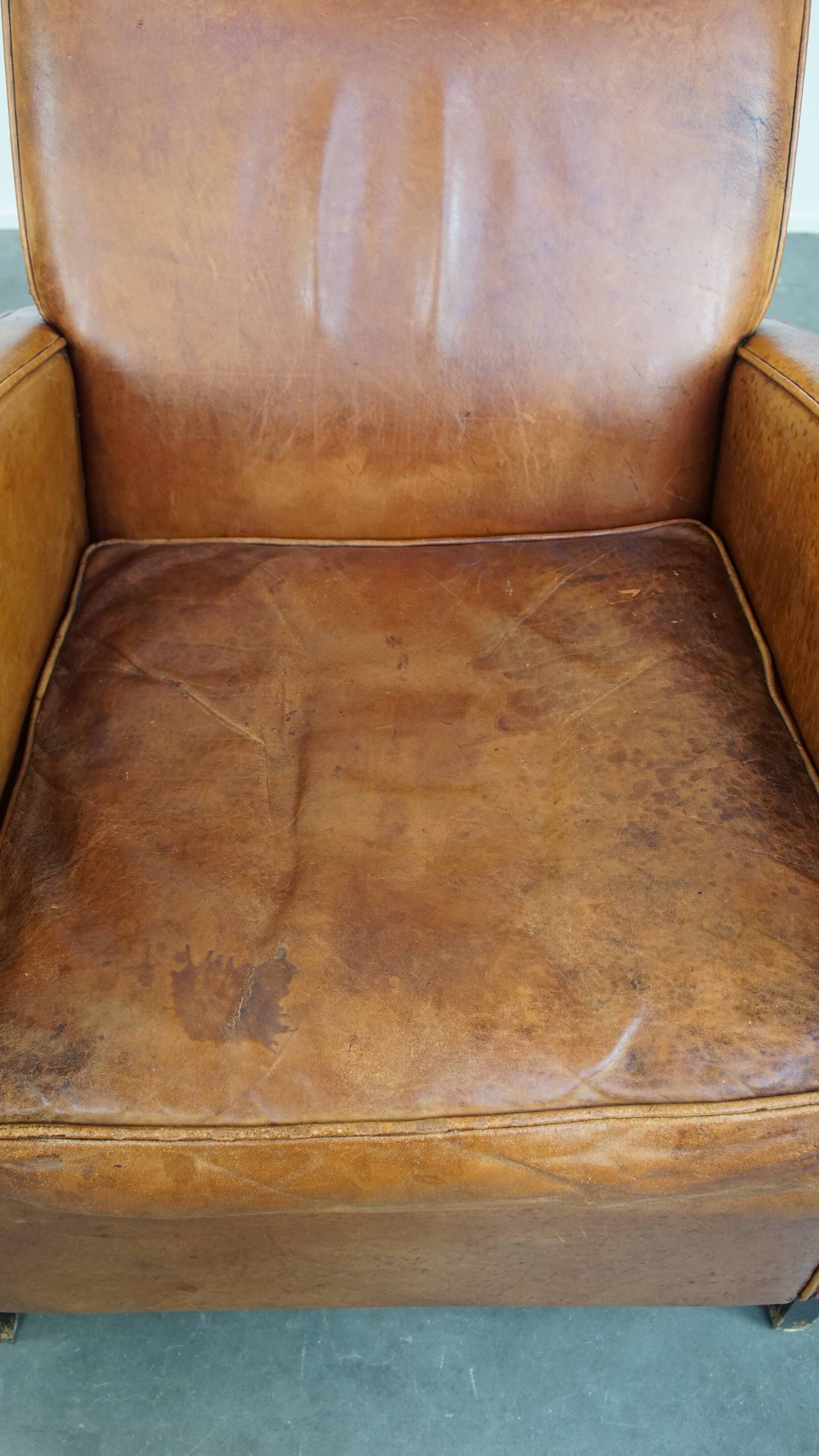 Characteristic sheepskin design armchair in beautiful warm cognac colours