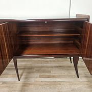 Mid-century mahogany buffet with teal glass and compartments with a drawer.