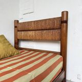 Brutalist style bed with chain and straw