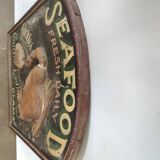Former Seafood restaurant sign in rare relief