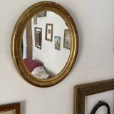Oval mirror in gilded wood.