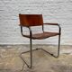 Vintage aluminum tube and tan leather armchair