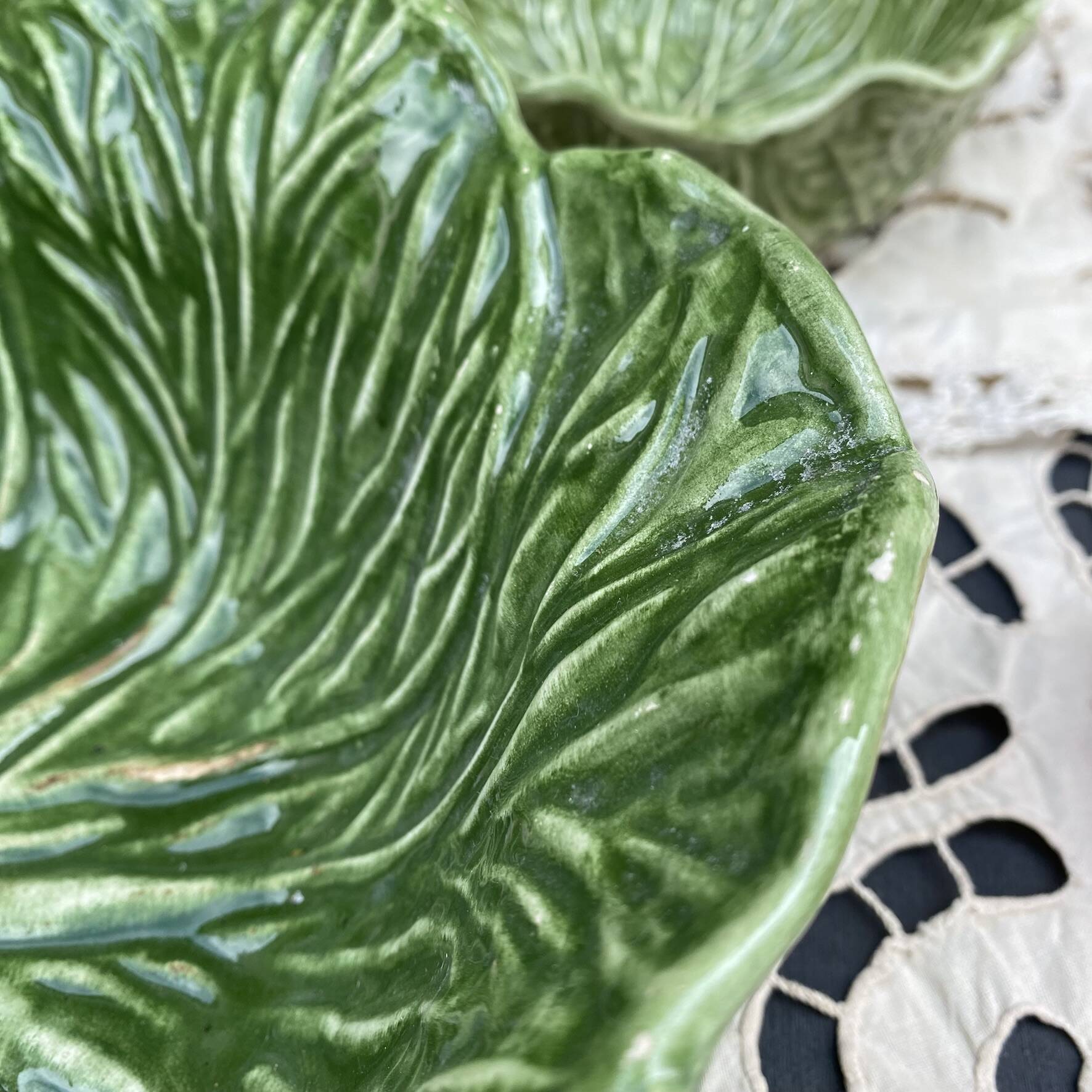 Large earthenware salad bowl in the shape of a cabbage leaf.