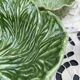 Large earthenware salad bowl in the shape of a cabbage leaf.