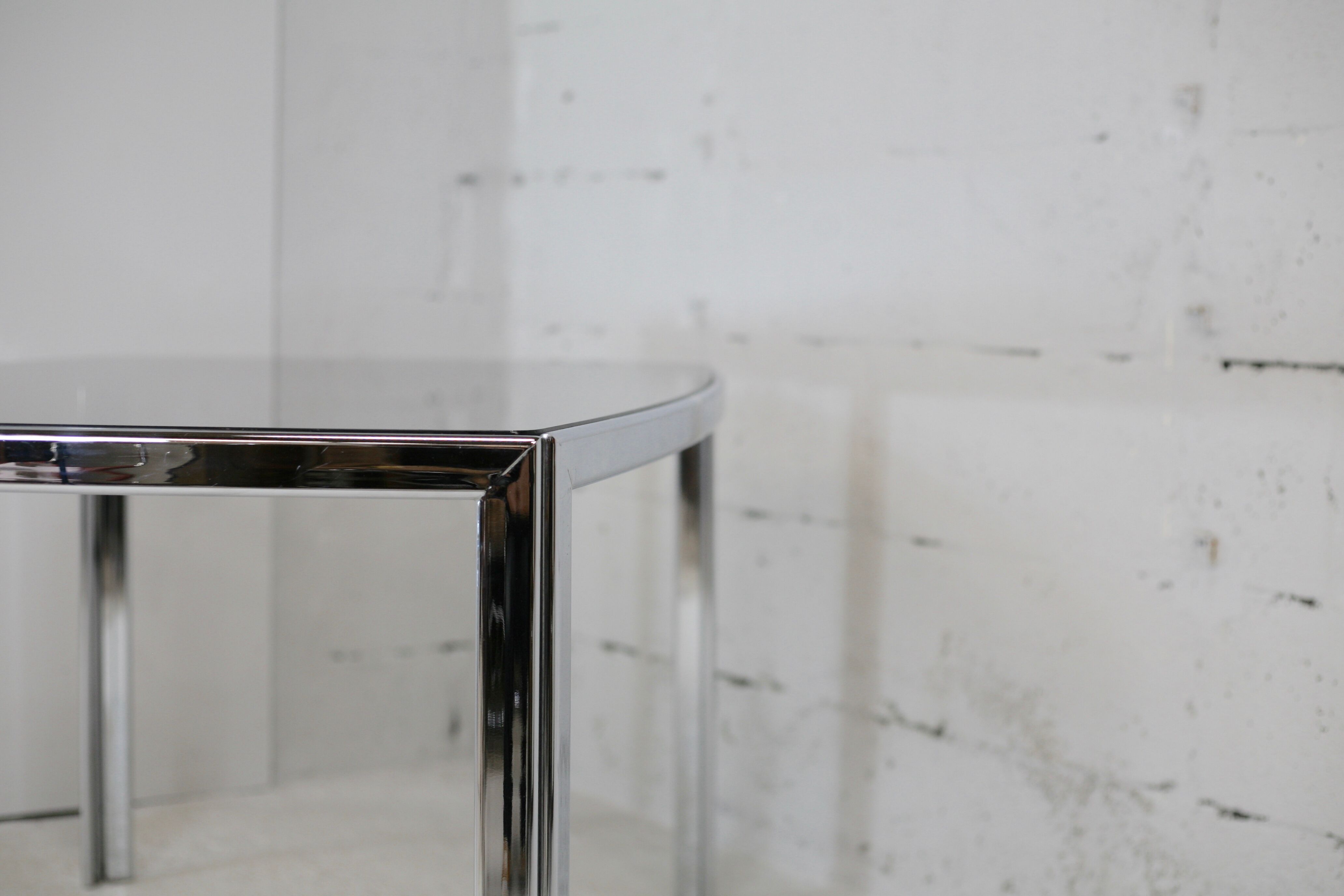Living table. chrome metal, curved smoked glass slab, france, circa 1970.