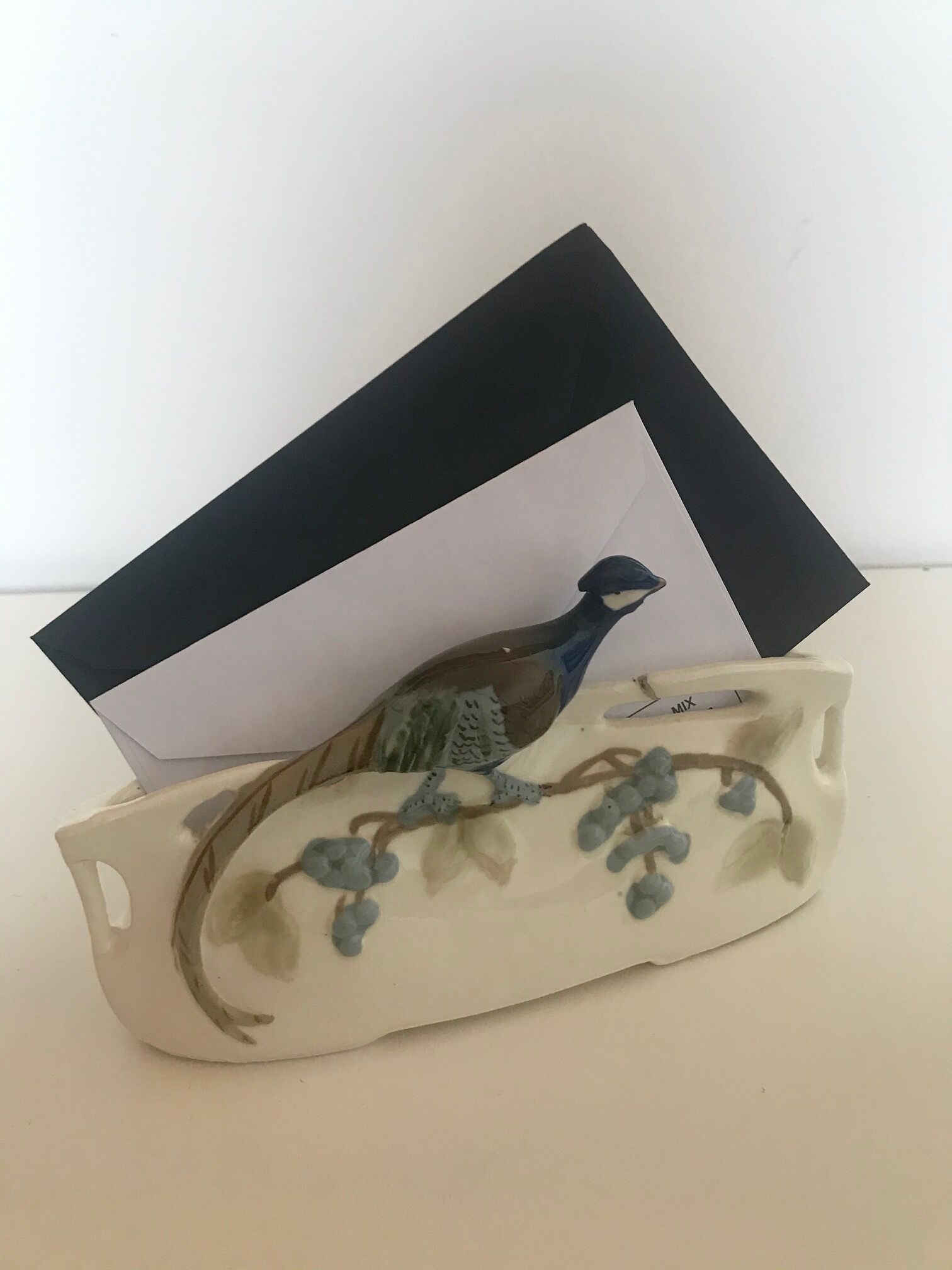 Letter door in earthenware topped with a peacock