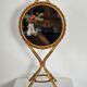 Vintage double-sided round mirror on a rattan stand.