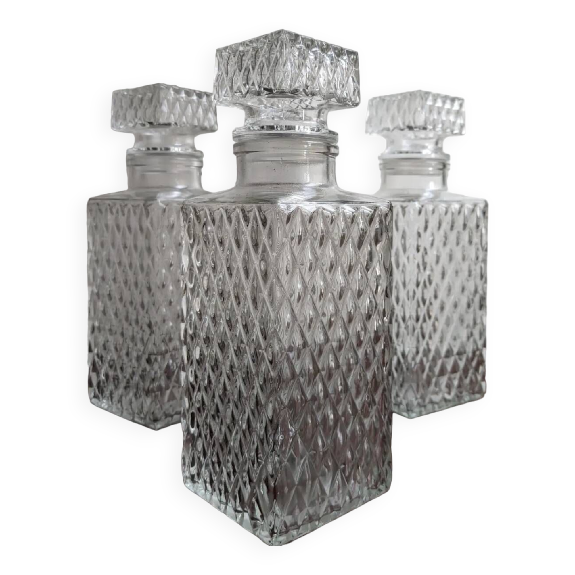 3 diamond-patterned chiseled glass carafes