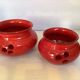 Pair of red Scandinavian candle holders.
