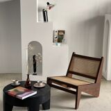 Reclined armchair in canned teak in natural wood