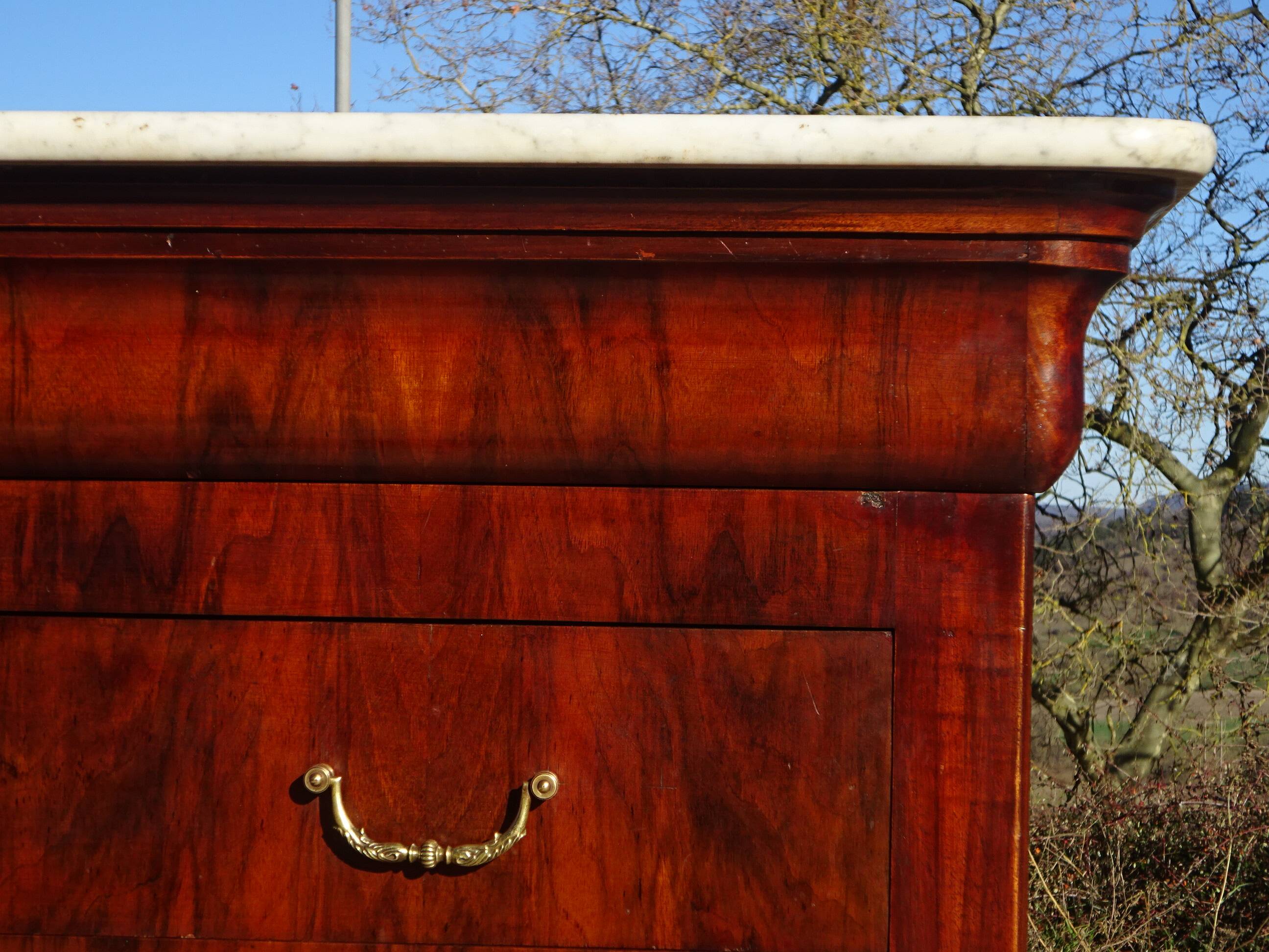 Antique mahogany chest of drawers with white marble.