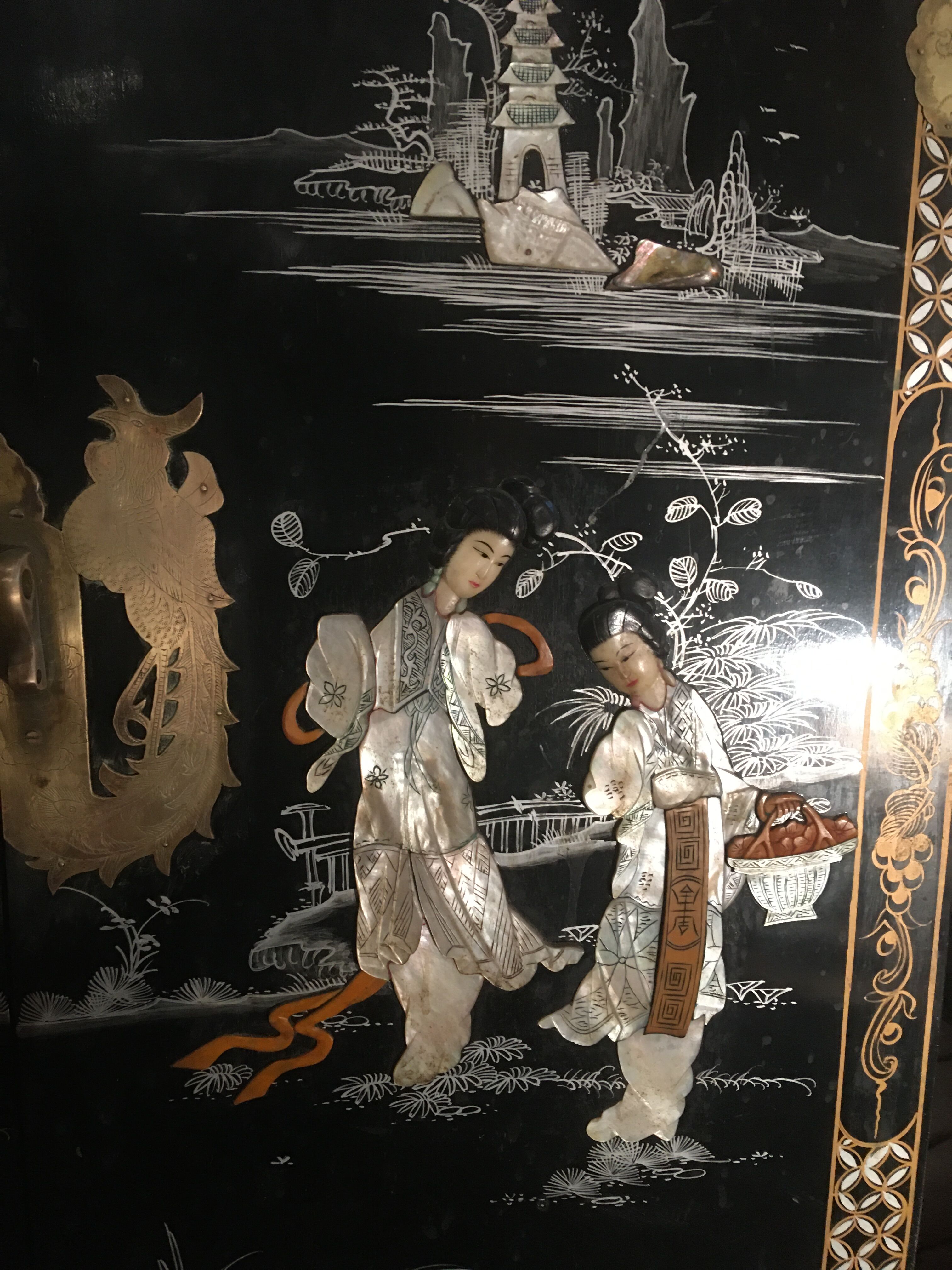 Asian lacquer cabinet with mother-of-pearl relief pattern