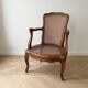Low Louis XV armchair in wood and cane