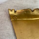 Small corner console in resin with a gold finish.