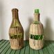 Glass bottles and woven rattan