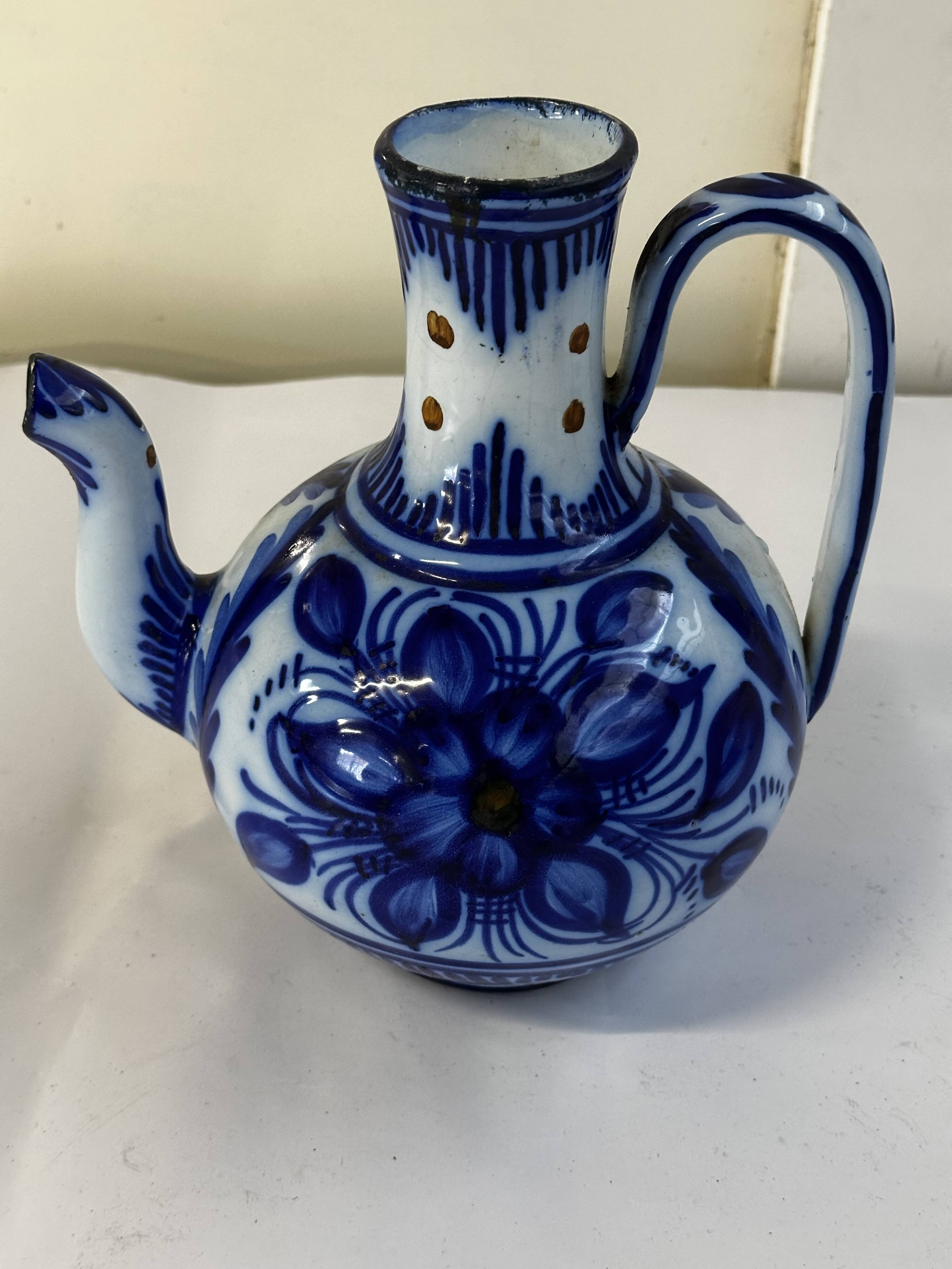 Glazed ceramic carafe with floral decoration