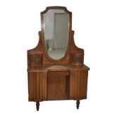 Large vintage brown wooden dressing table with an oval mirror and built-in storage.