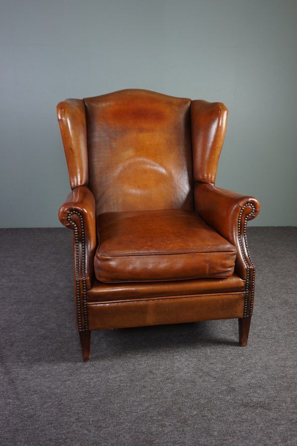 Eared armchair in patinated sheepskin