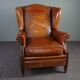 Eared armchair in patinated sheepskin