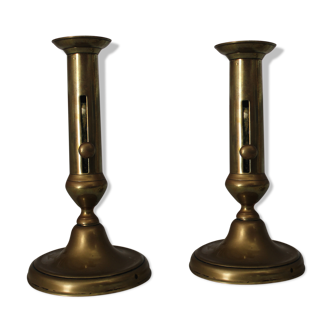 Pair of brass pusher candlesticks