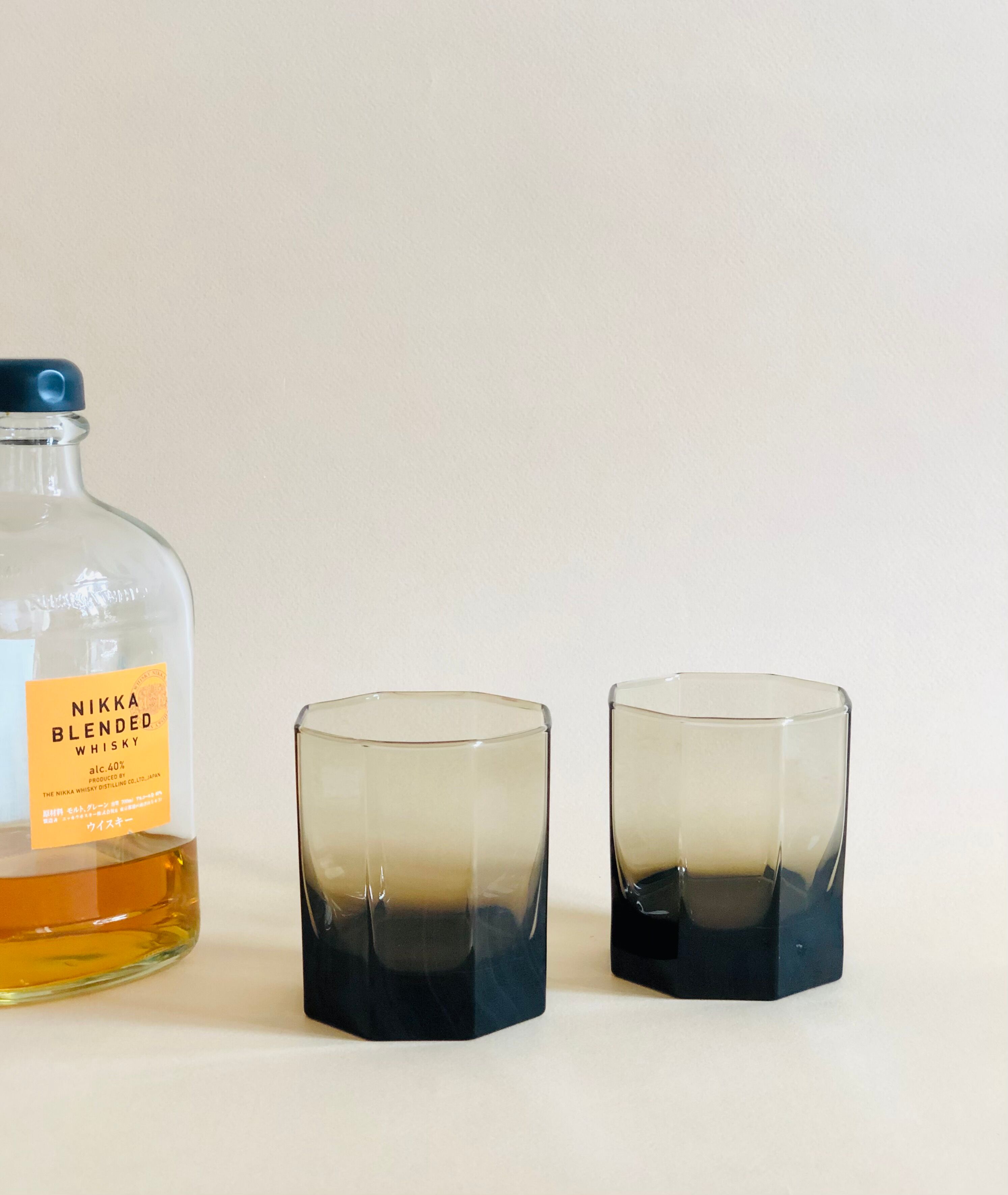 Pair of octagonal black glass whiskey glasses