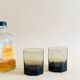 Pair of octagonal black glass whiskey glasses