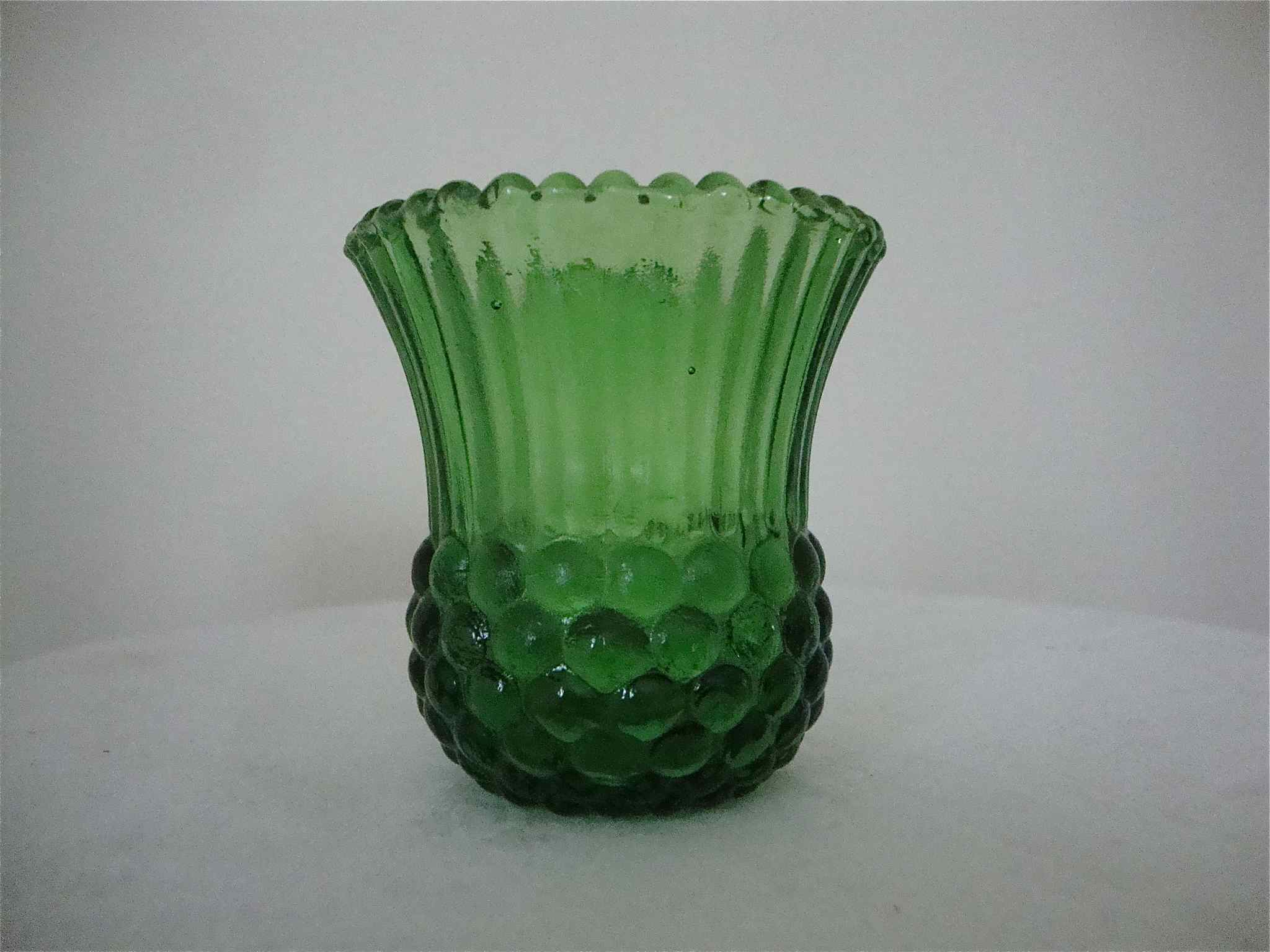 Very small green vase bottle