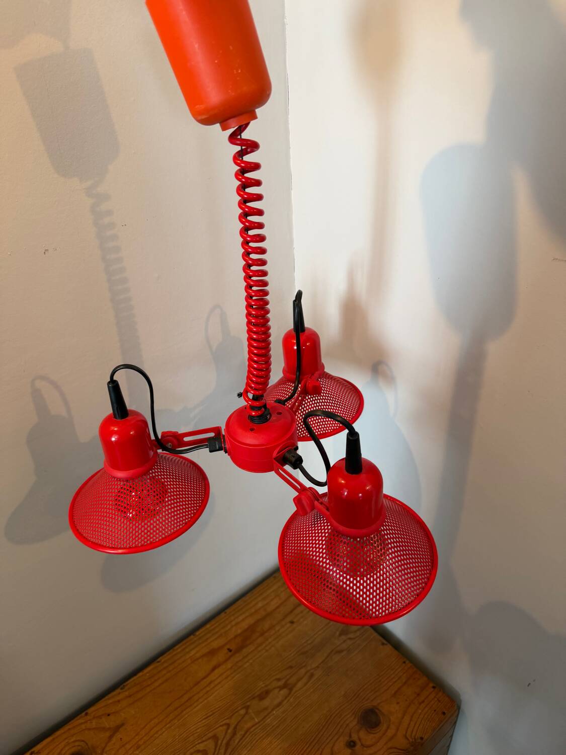 Three-lamp suspension in Memphis design style in red metal.