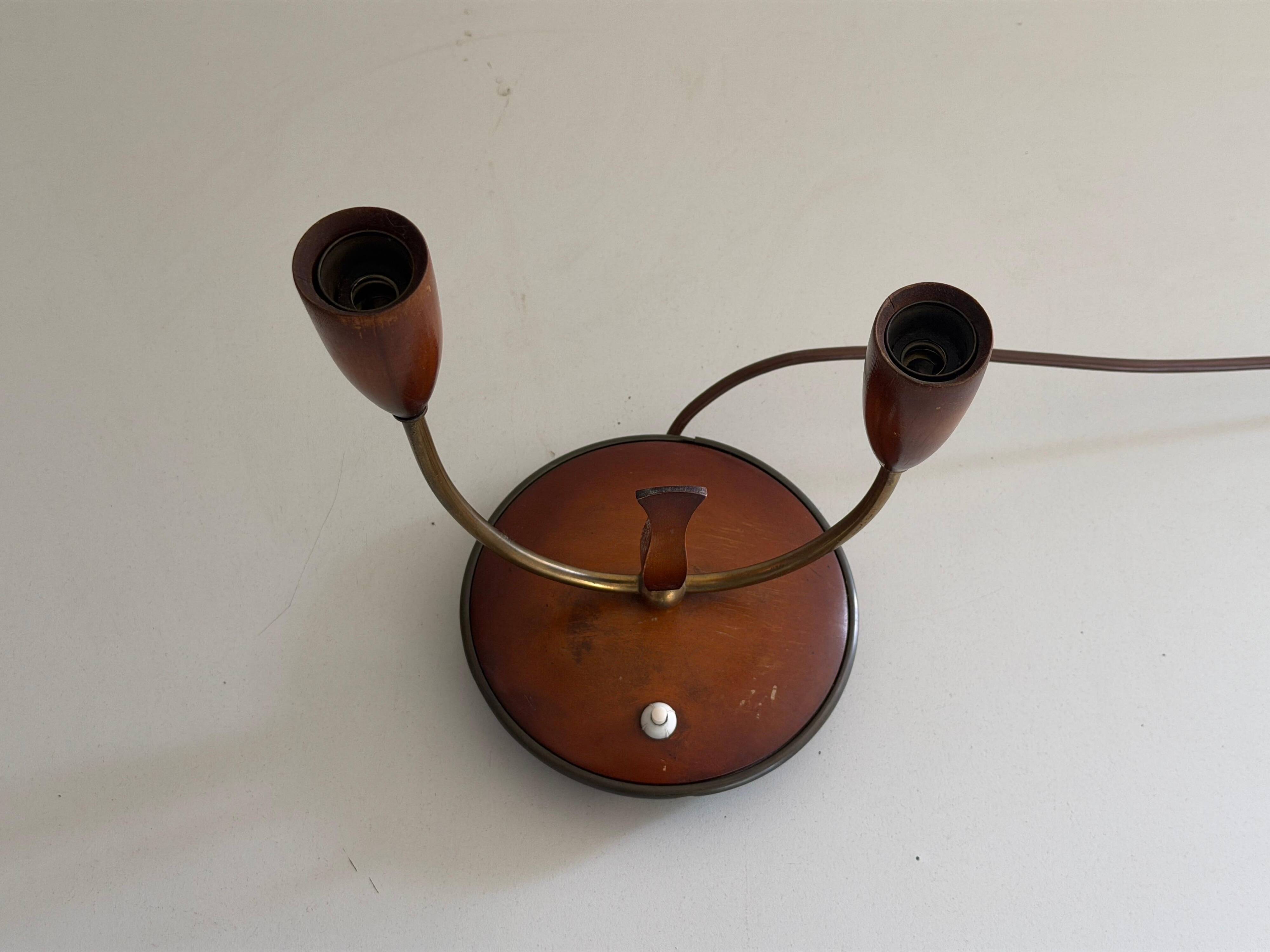 Simple double-headed table lamp in wood and brass, 1960s, Germany.