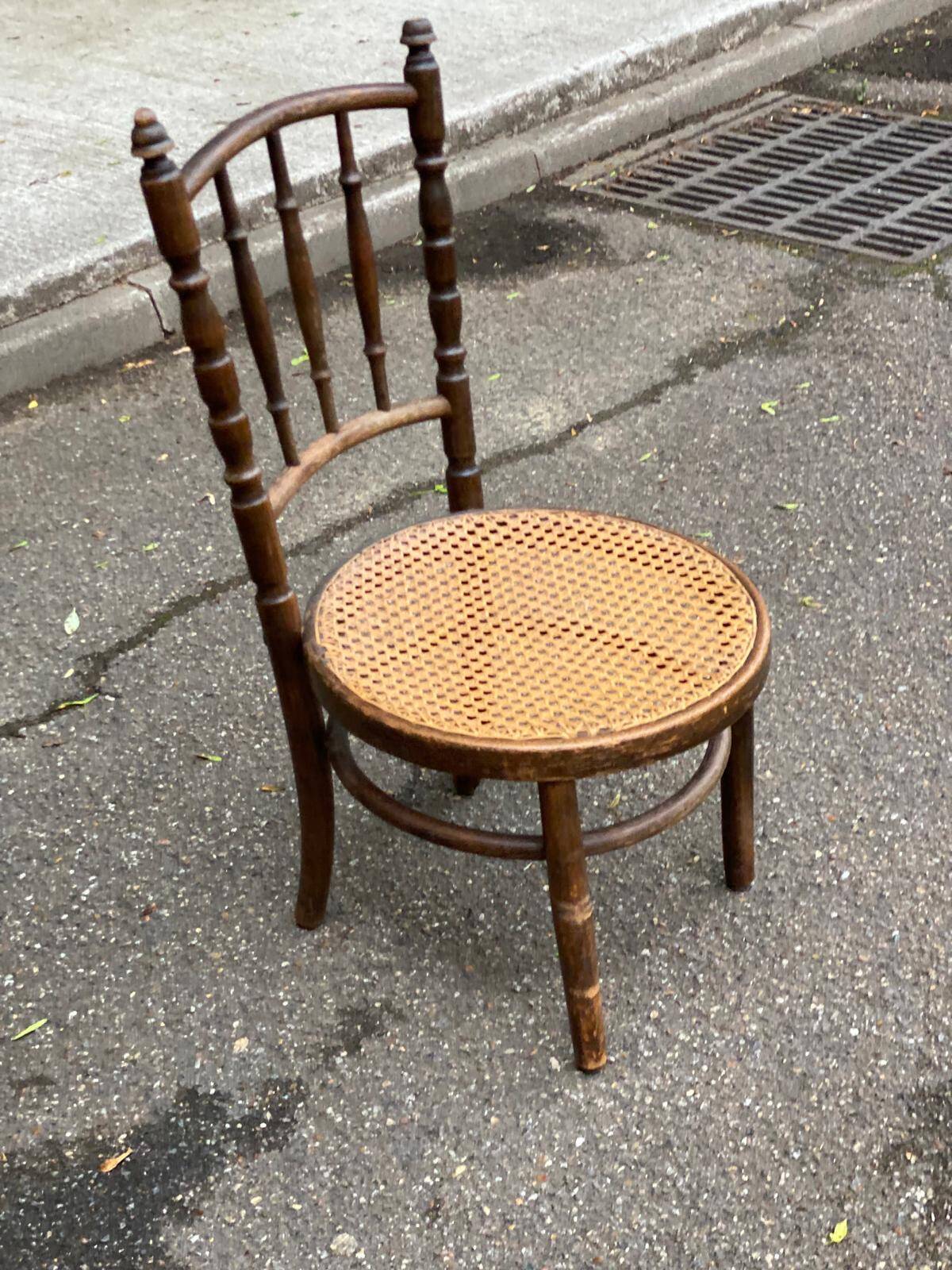 Vintage 19th-century bistro chair made of curved solid wood and caned in the Thonet style.